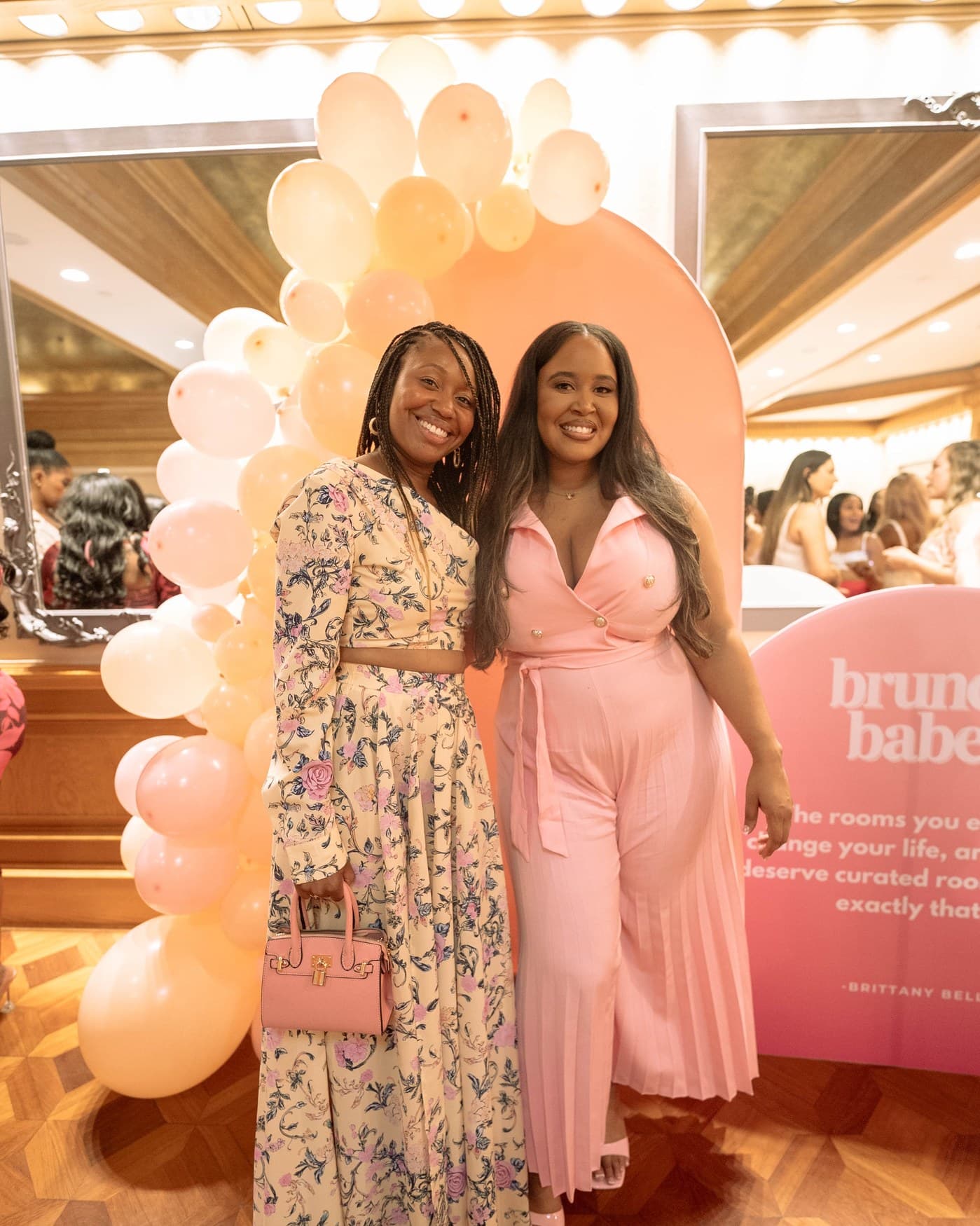 Two guests at the Brunch Babez step and repeat.