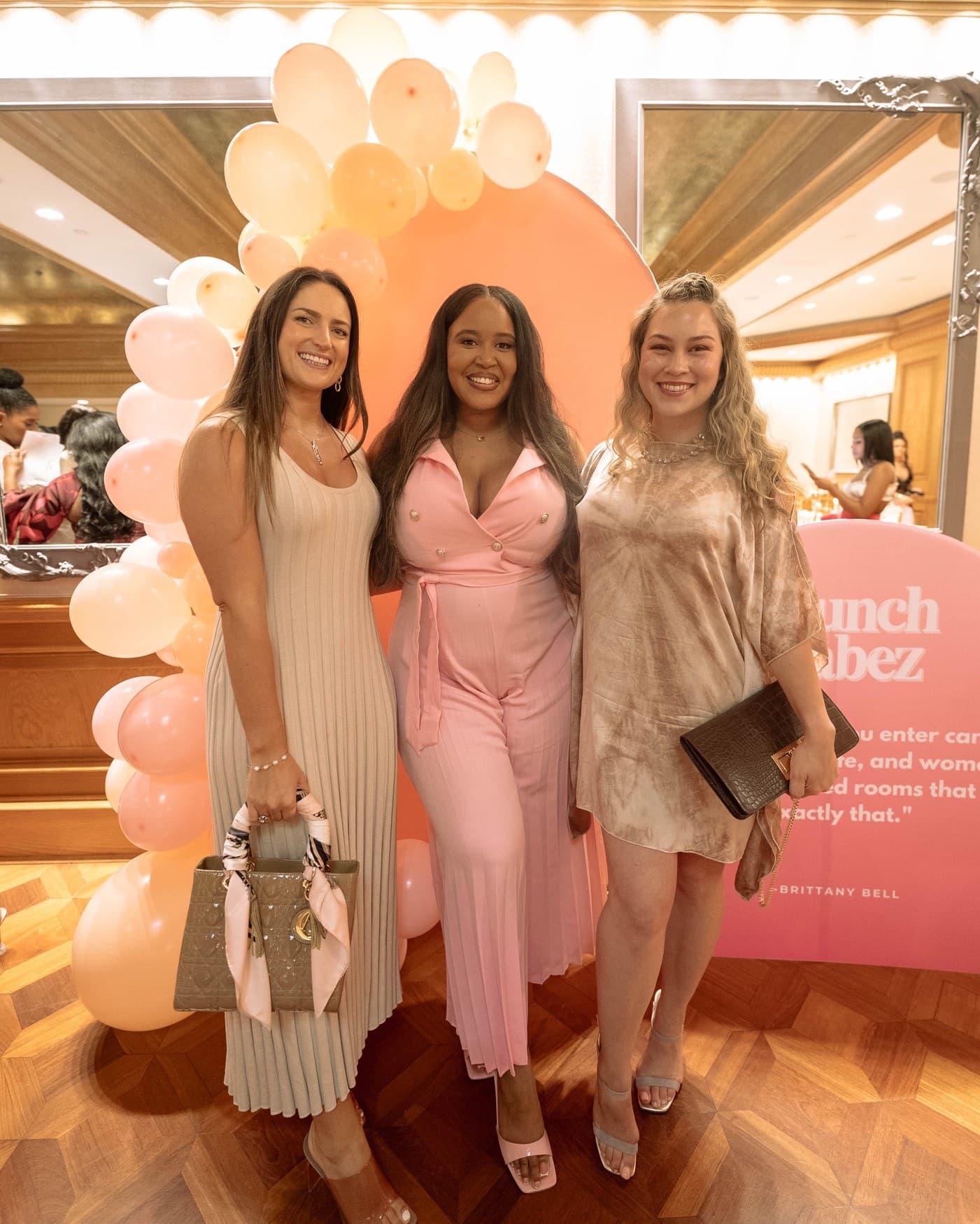 Brittany Bell with two guests at the Brunch Babez balloon installation.