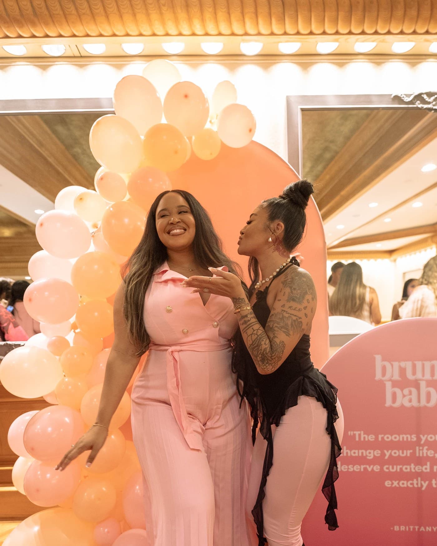 Brittany Bell and a guest at the Brunch Babez board and balloon installation.