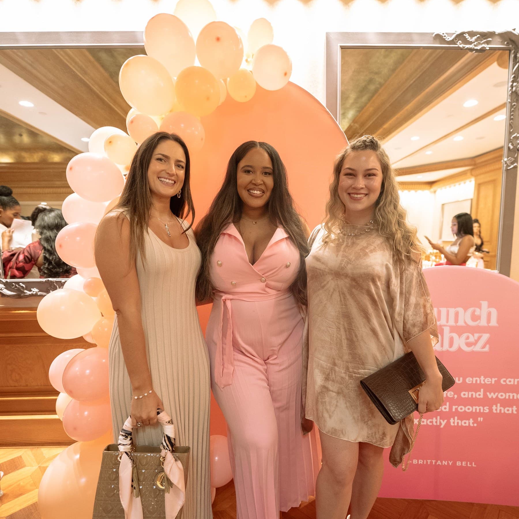 Brittany Bell with two guests at the Brunch Babez balloon installation.