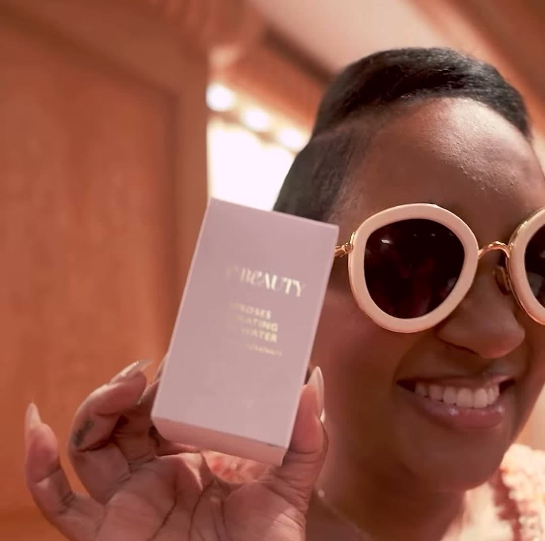 A guest holding up her Vie Beauty rose water from the gift bag.