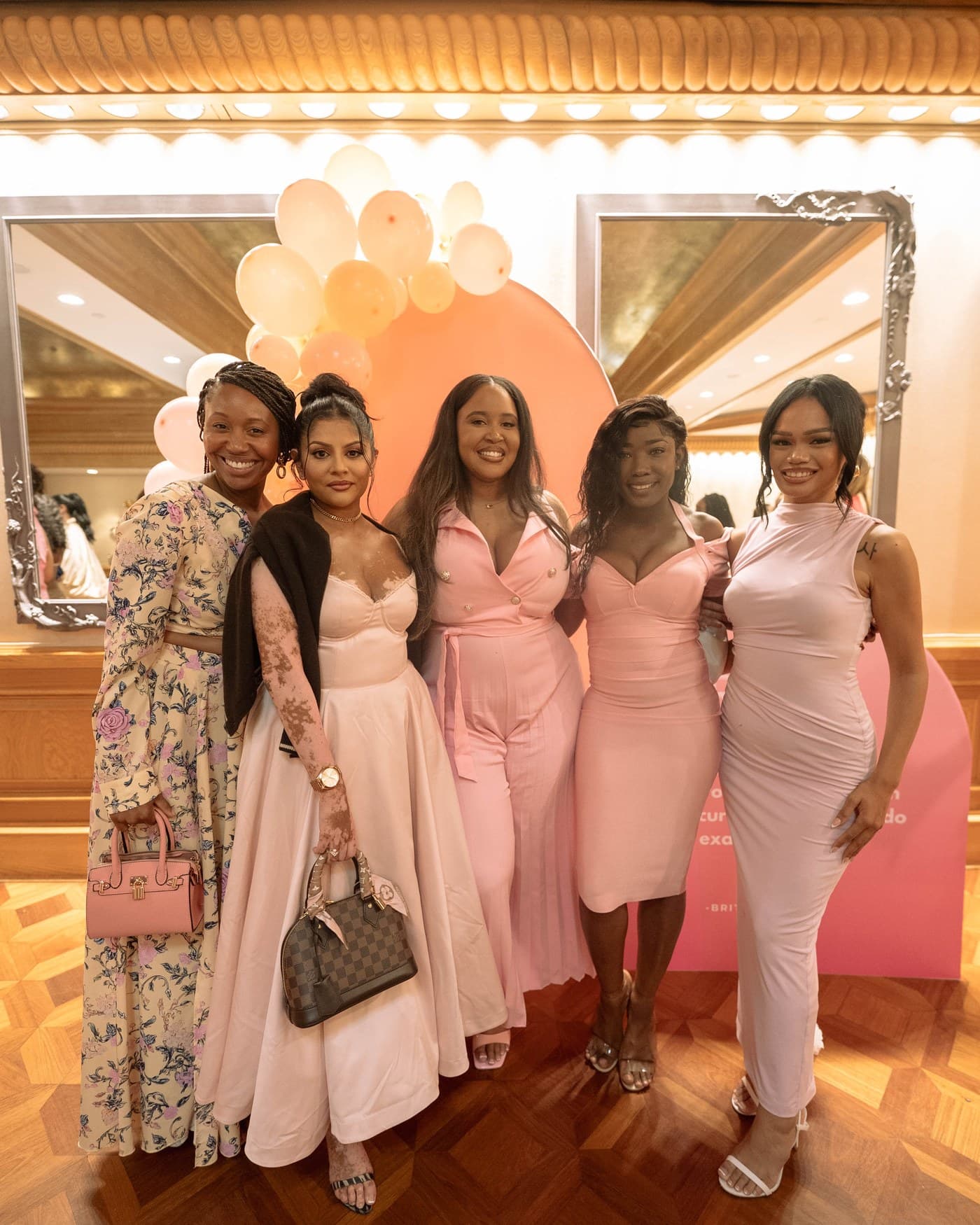 Five guests together at the Brunch Babez balloon installation.