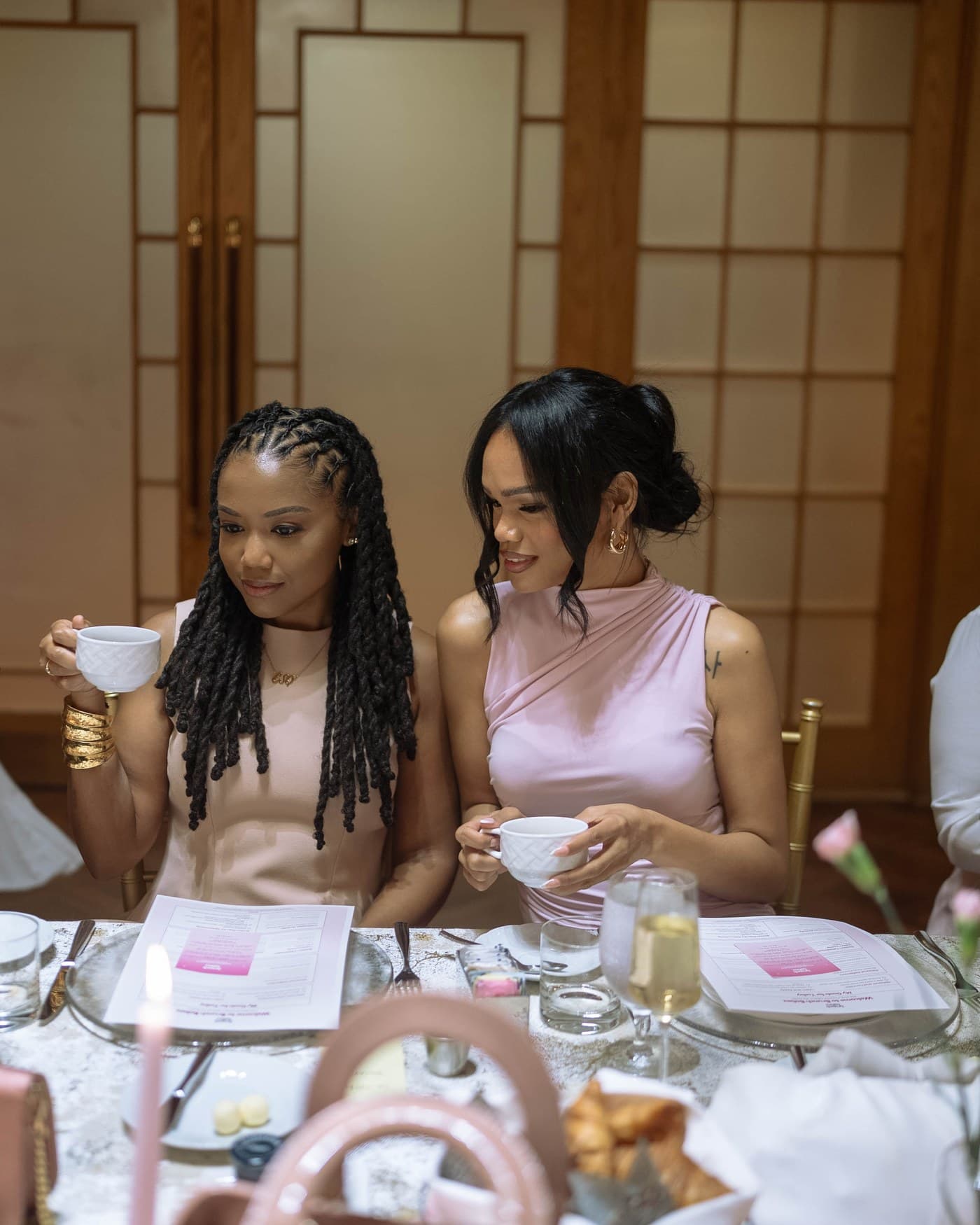 Two guests over tea at the Brunch Babez table.
