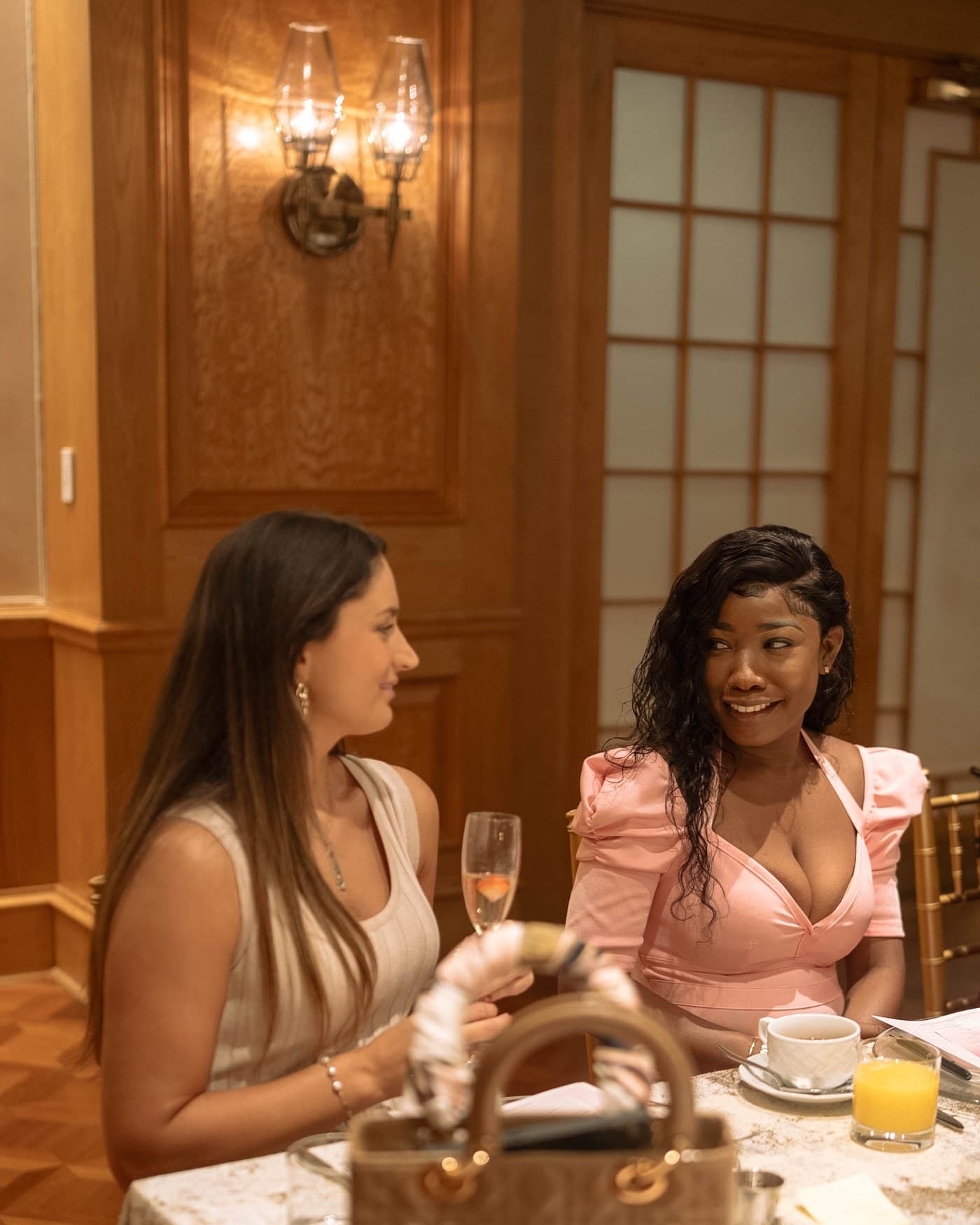 Two guests over mimosas at the Brunch Babez table.